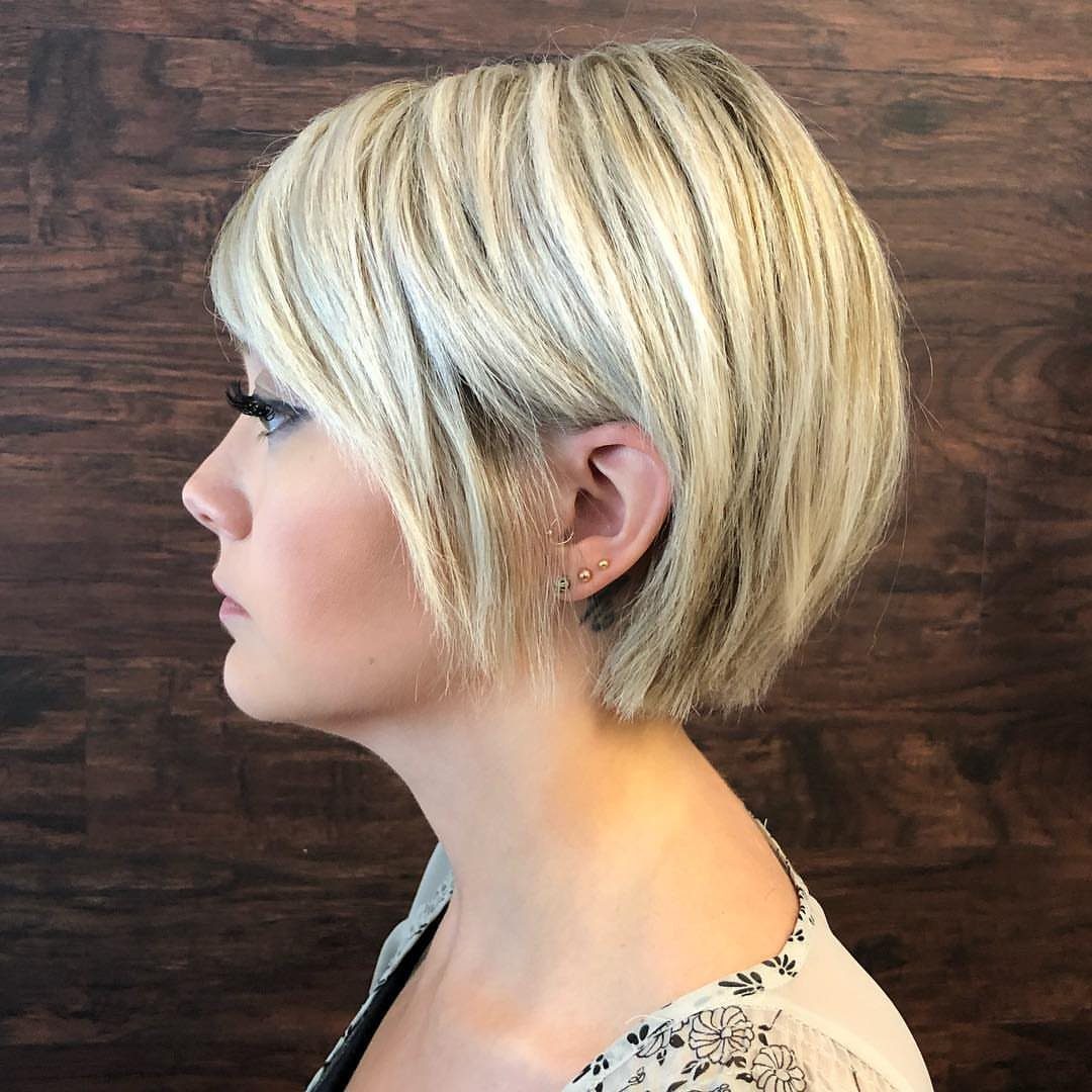 Profile of a woman showing a highlighted blonde long pixie with layered sides