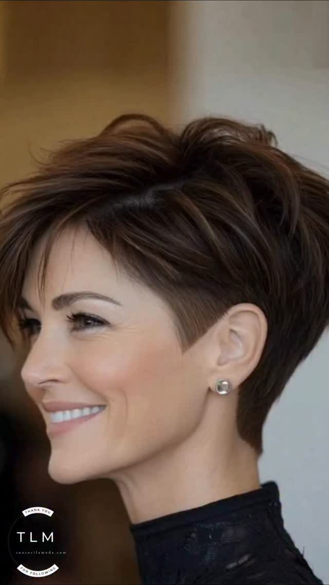 Woman with dark brown long pixie haircut and wispy swept fringe