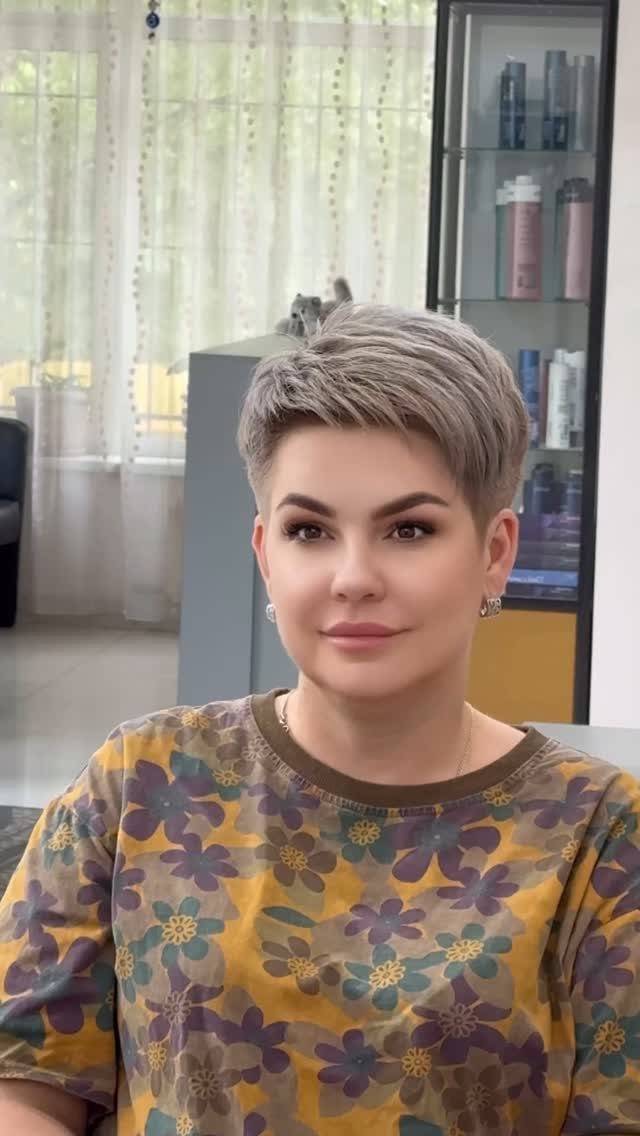 Woman with a short silver-blonde pixie haircut in a salon