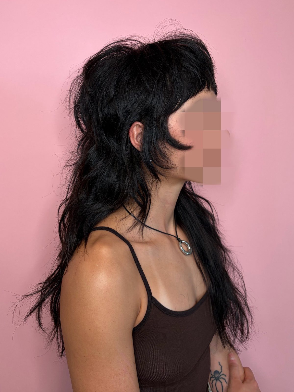 Long black shag haircut with choppy bangs and tousled layers