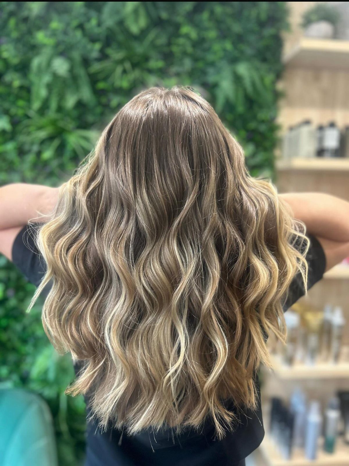 Shoulder-length highlighted hair styled in loose, beachy waves