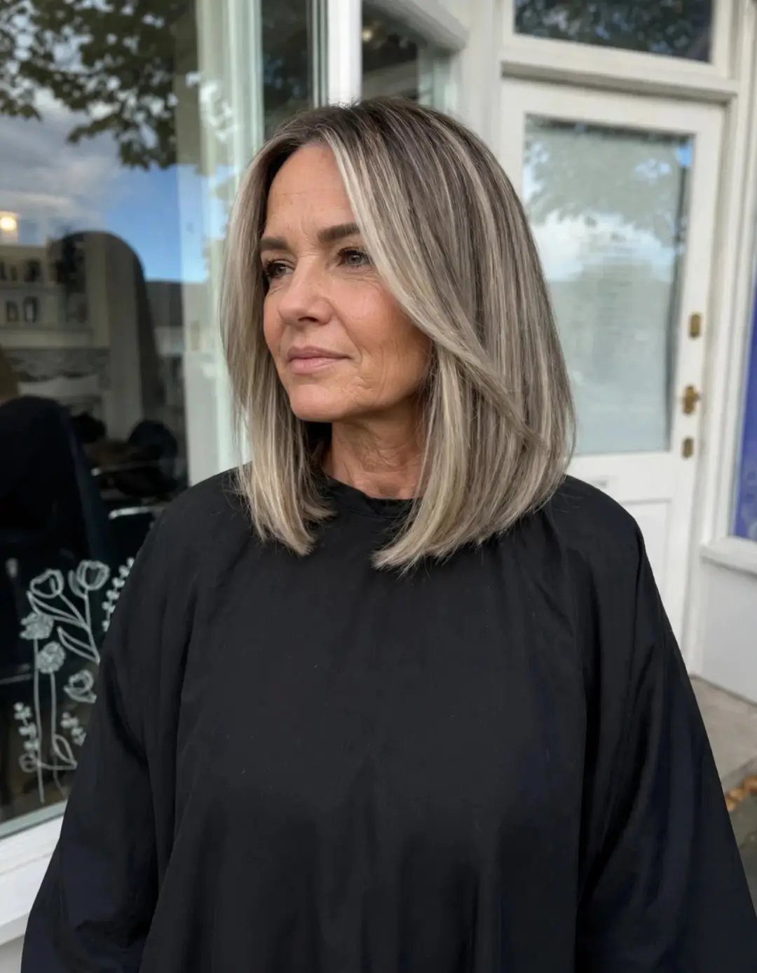 Woman with a shoulder-length blonde bob and softly curved ends