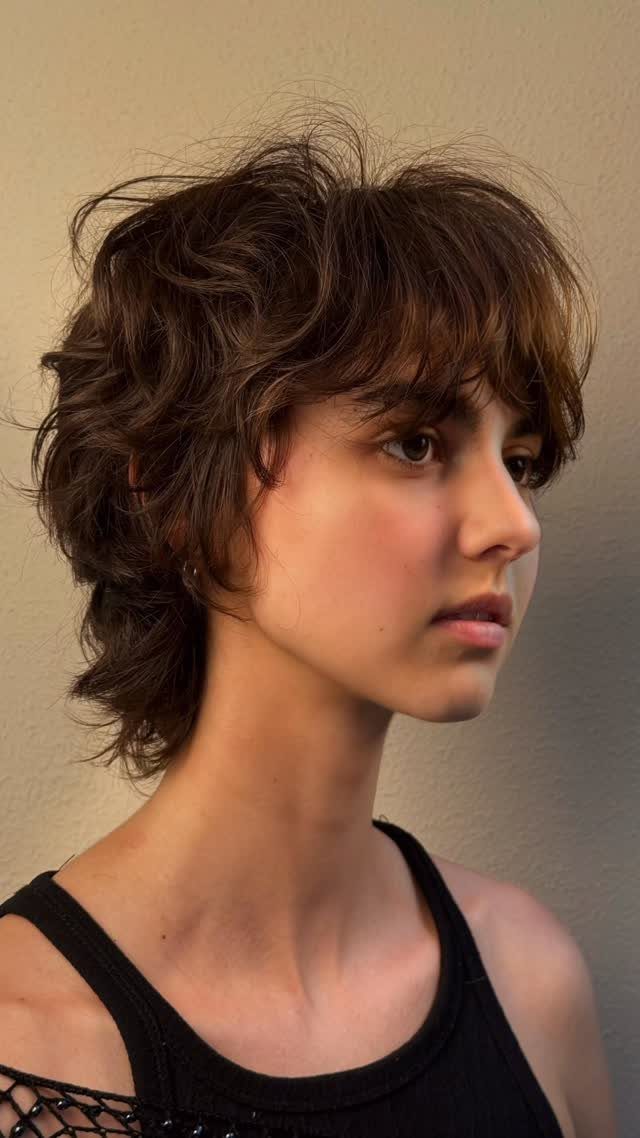 Dark layered shag mullet with short fringe and longer hair at the back