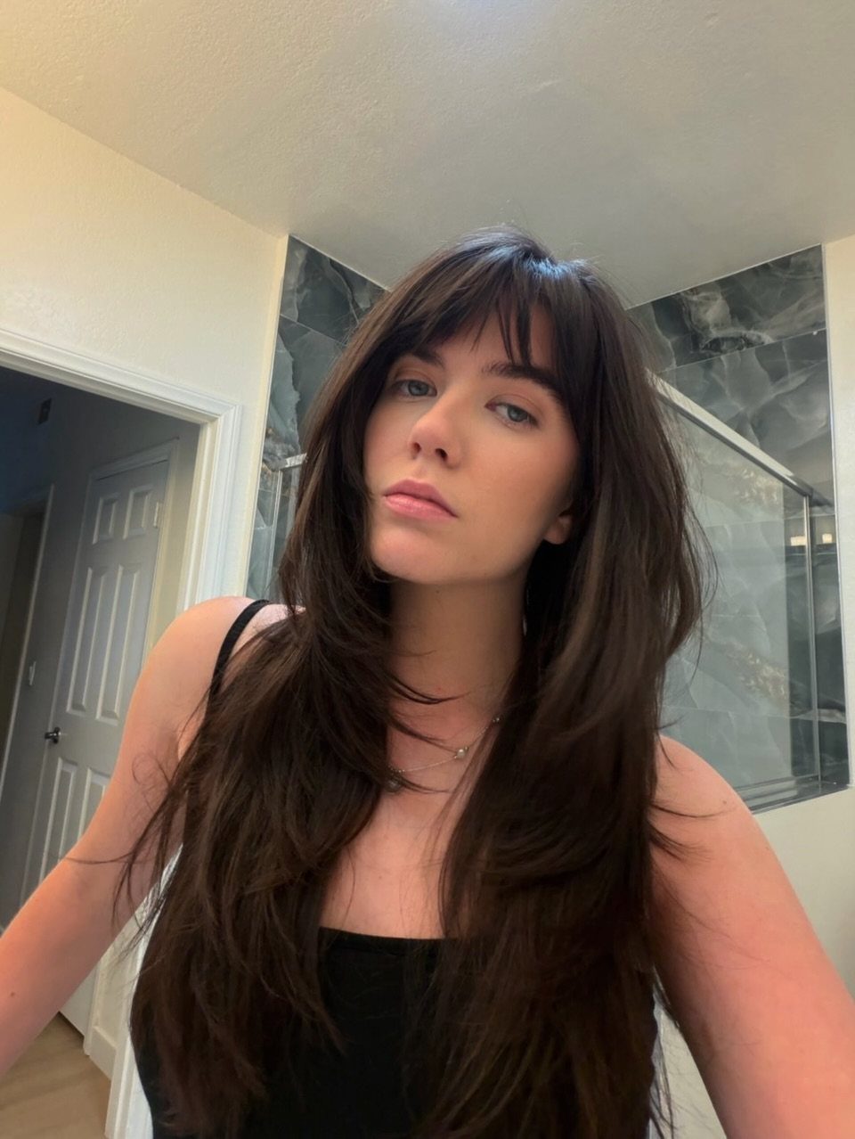 Straight brunette shag with long soft layers and blunt bangs