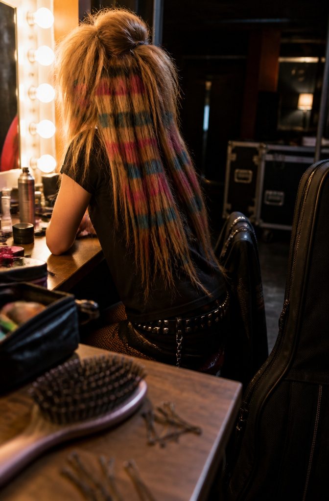 Wearer with colorful raccoon stripes teased crown and extension lengths