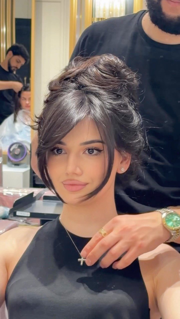 Woman in a salon with an updo and long, straight face-framing strands