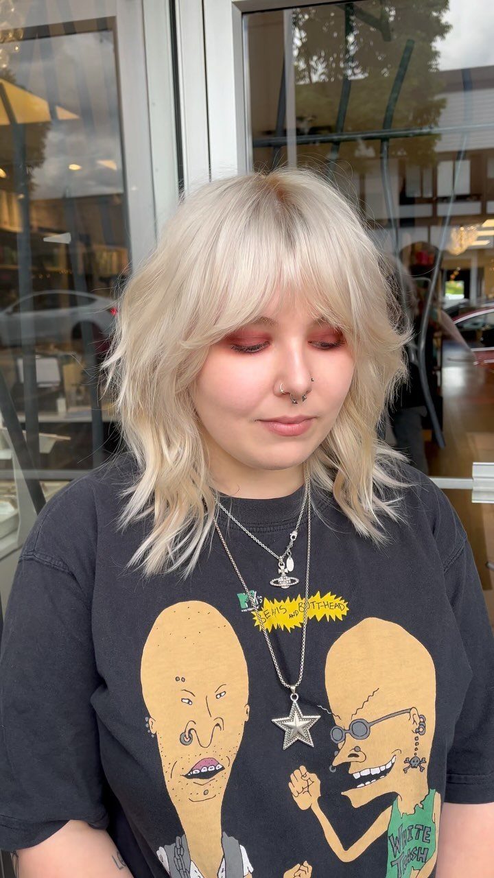 Platinum-blonde shag haircut with layered ends and wispy bangs