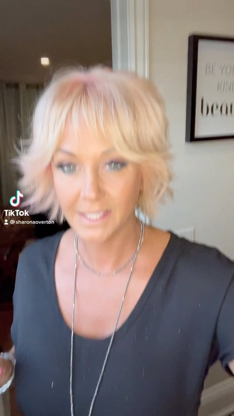 Woman showing a tousled short layered bob with wispy bangs