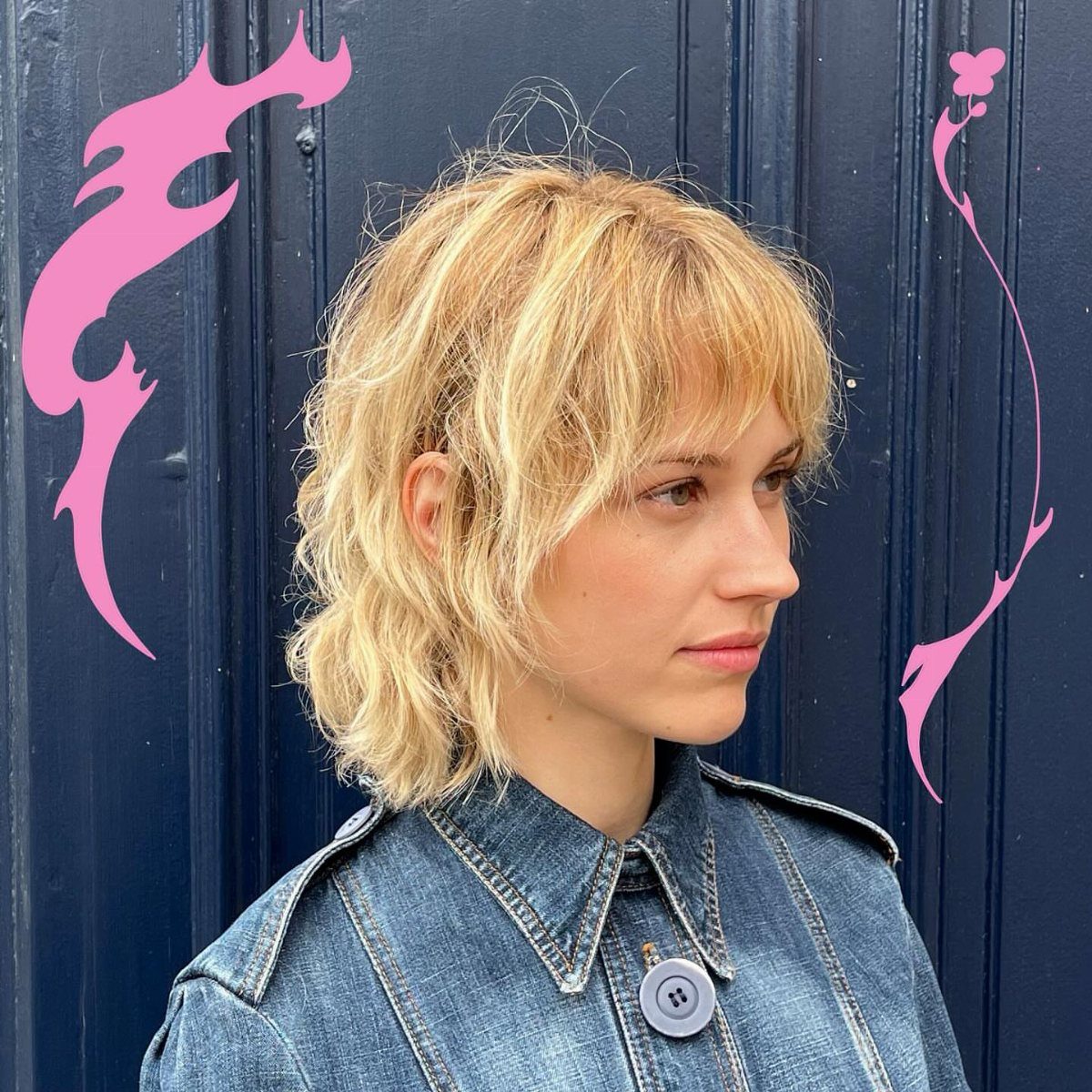 Woman showing a choppy blonde layered shag with wispy bangs