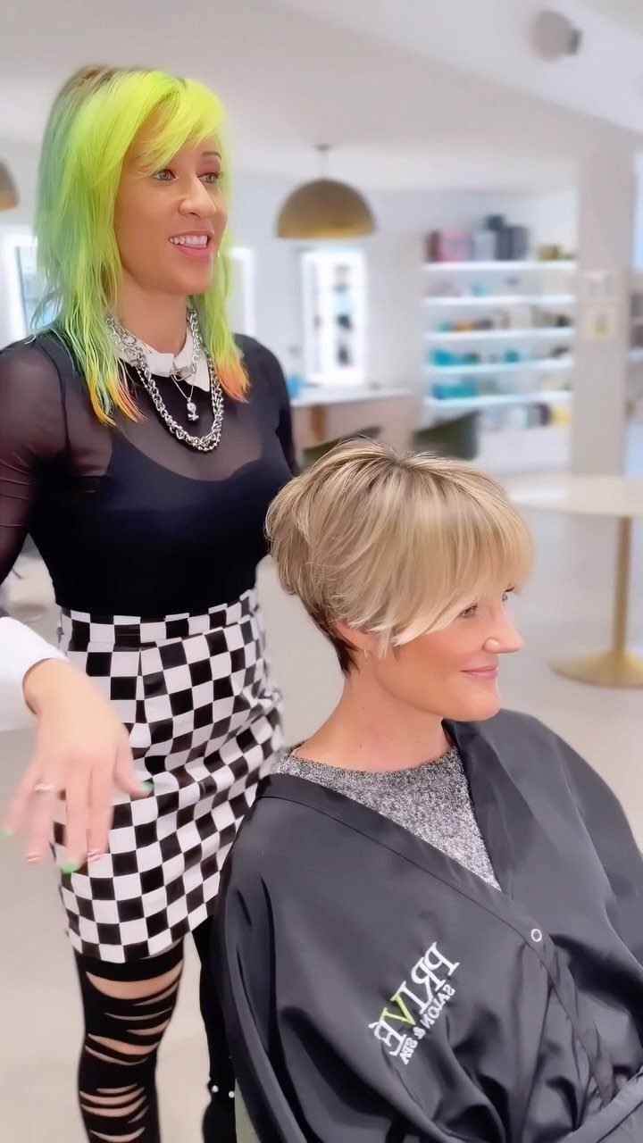 Blonde pixie shag with side-swept bangs on a seated salon client