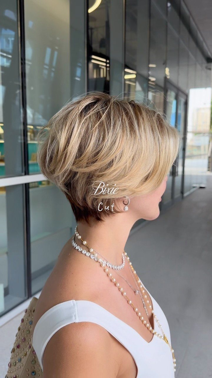Short graduated blonde bixie with layered crown and tapered dark nape