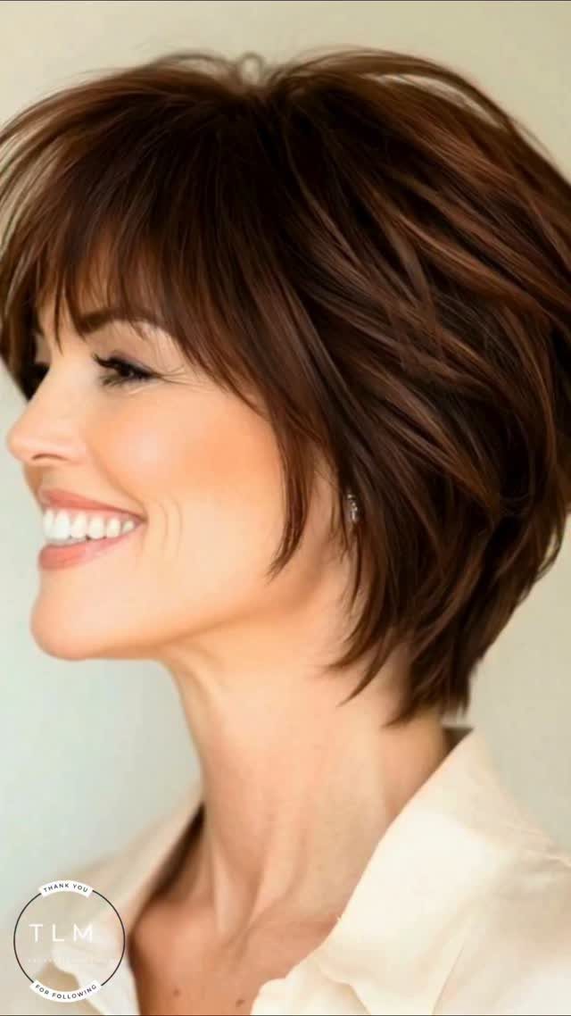 Woman with a layered brunette long pixie and side-swept bangs