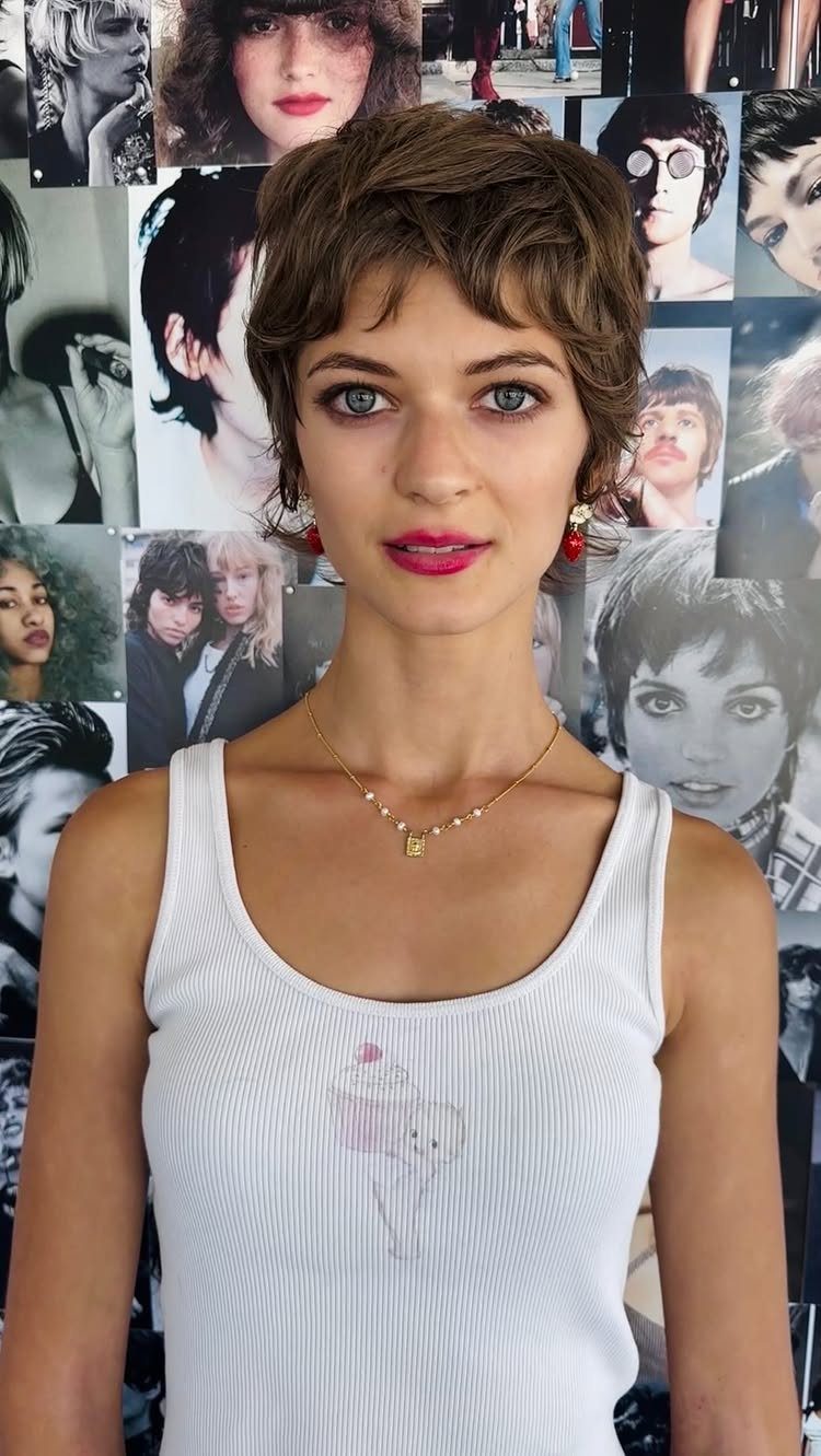 Woman showcasing a tousled textured brown pixie haircut against hairstyle photographs