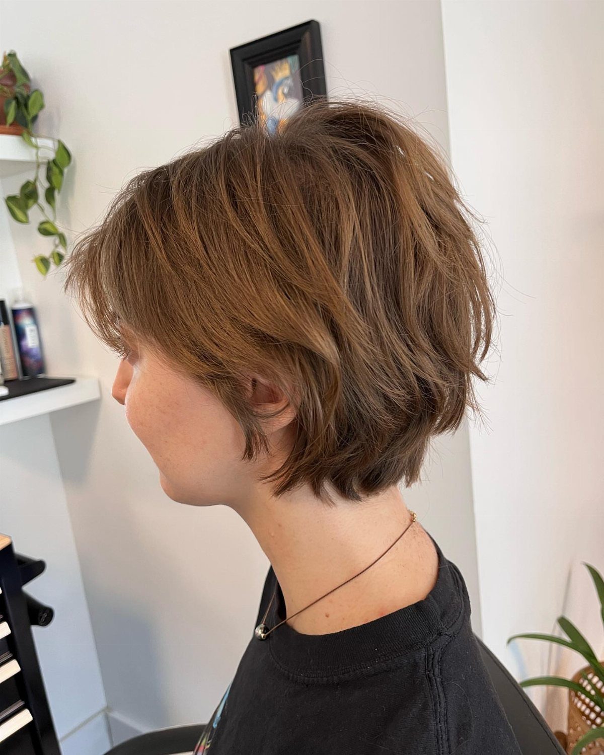 Short wavy brown crop with wispy layers shown from the side