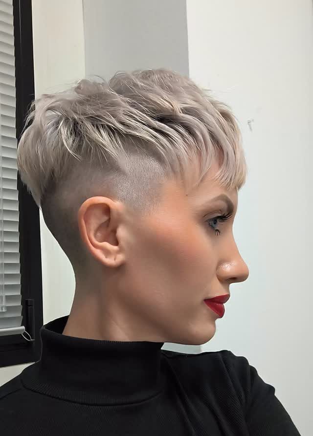 Profile of a person with a pale blonde pixie and closely shaved sides