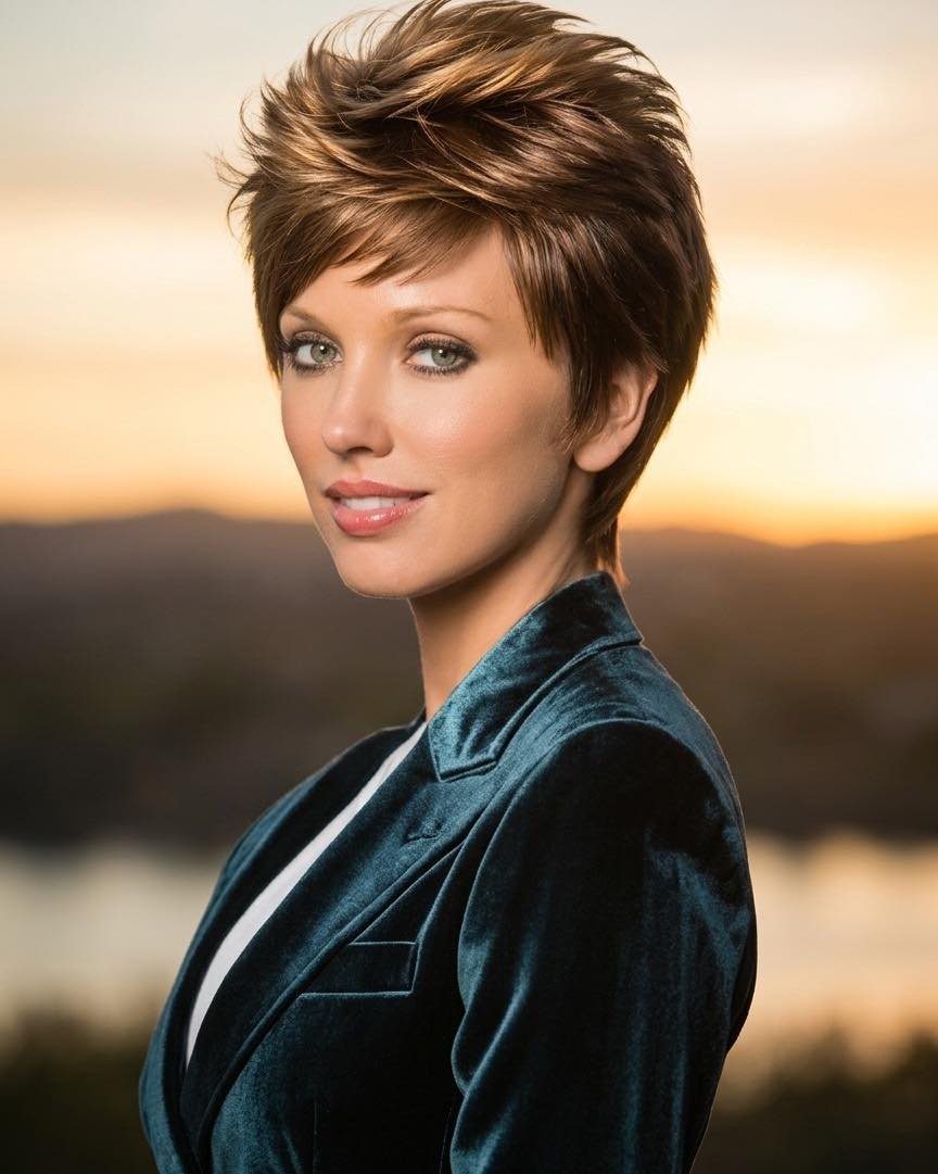 Woman with tousled brown pixie hair and side-swept, textured layers