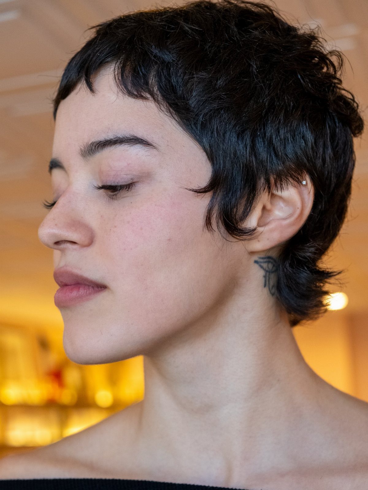 Short choppy pixie with uneven dark layers and a textured fringe