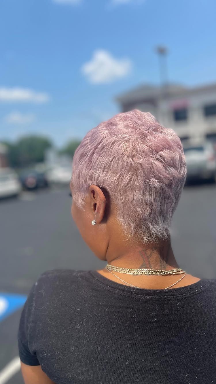 Pastel pink pixie cut with textured layers and tapered nape