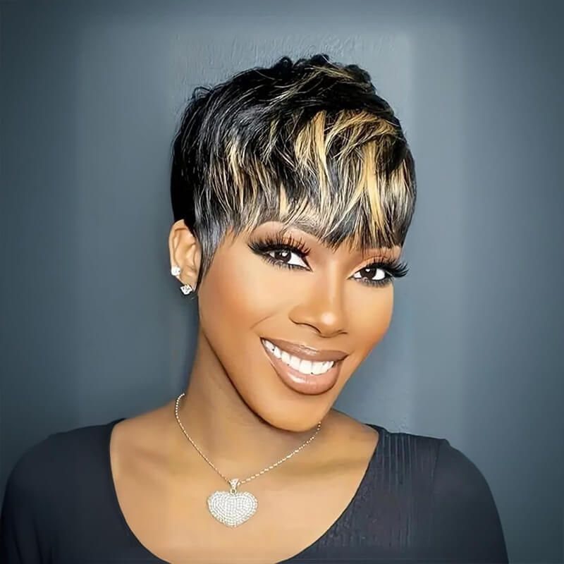 Woman with a short feathered pixie cut, blonde streaks, and wispy bangs