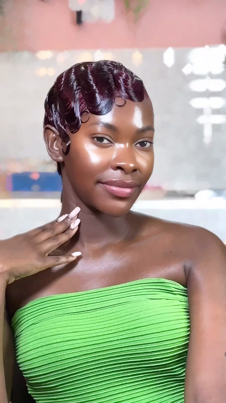 Woman with a glossy short pixie styled in sculpted finger waves