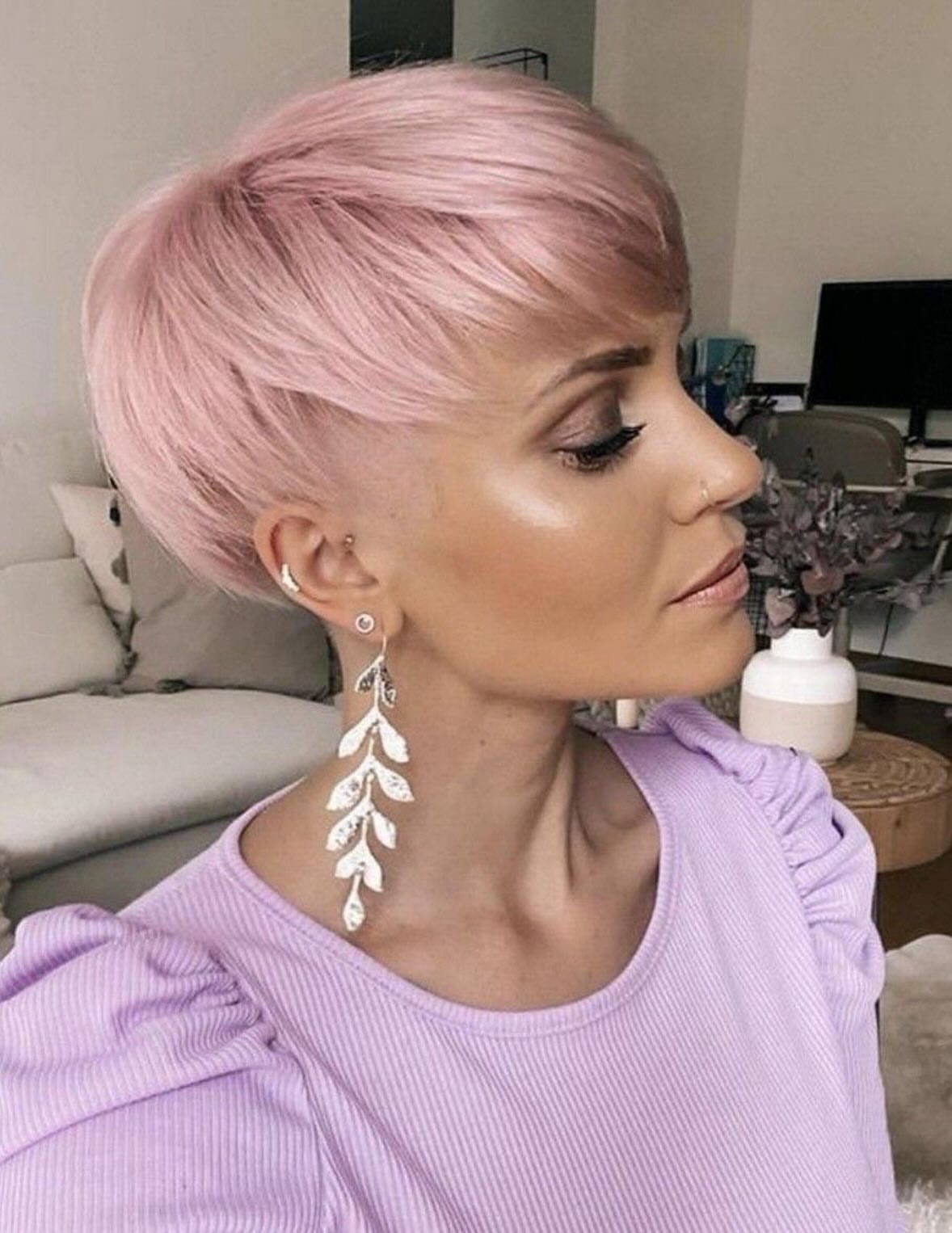 Woman showing a pale pink pixie cut with side-swept bangs