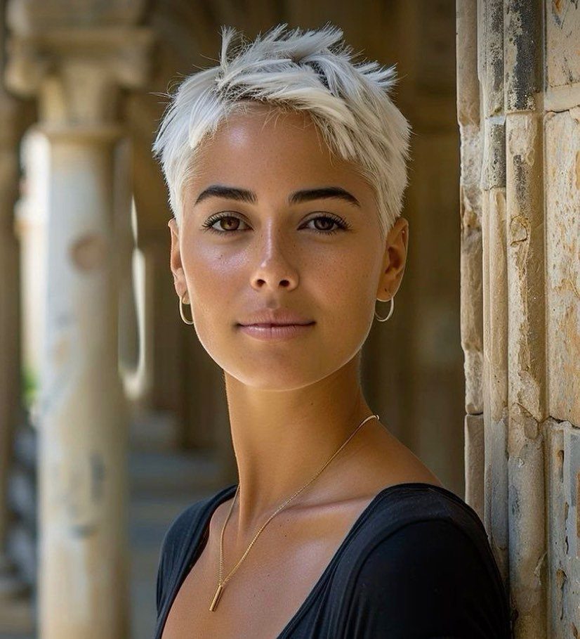 Woman with a platinum pixie cut styled in short, tousled spikes