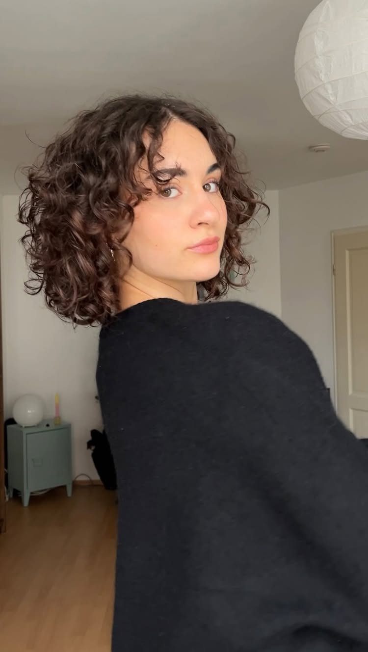 Short curly shag with layered curls framing the face