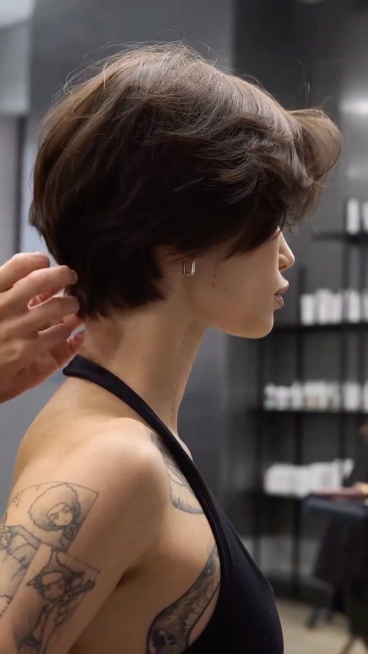 Short dark layered crop with airy texture shown in side profile