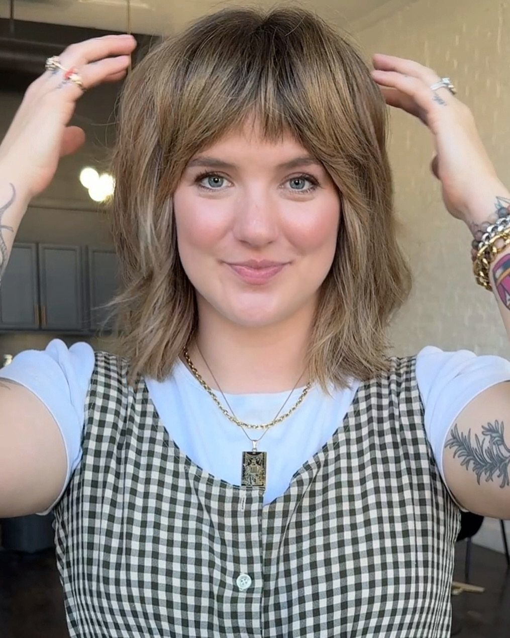 Person showing a short brown layered shag with soft fringe