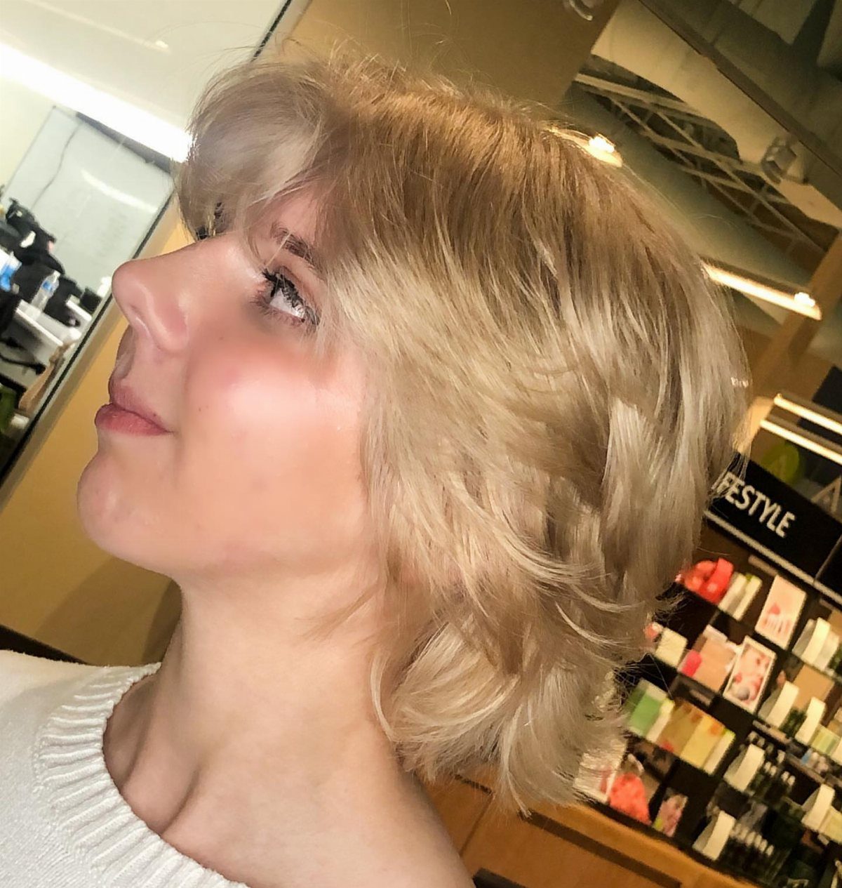 Blonde woman showing a layered bob with softly feathered ends