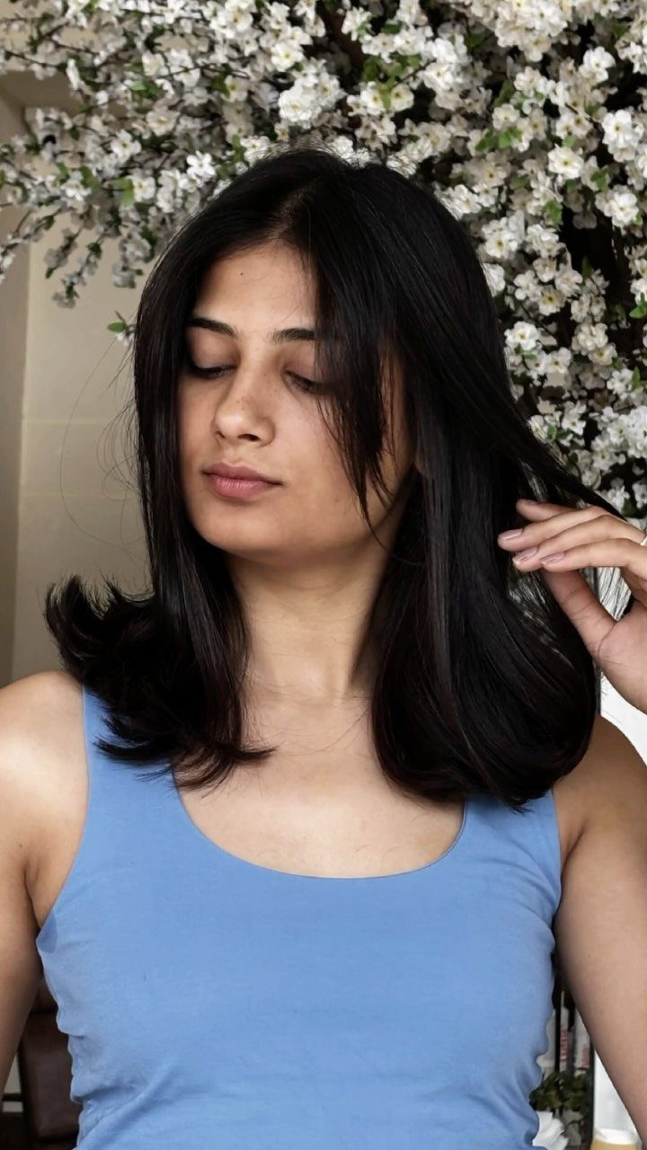 Woman showing straight dark shoulder-length bob with softly layered ends