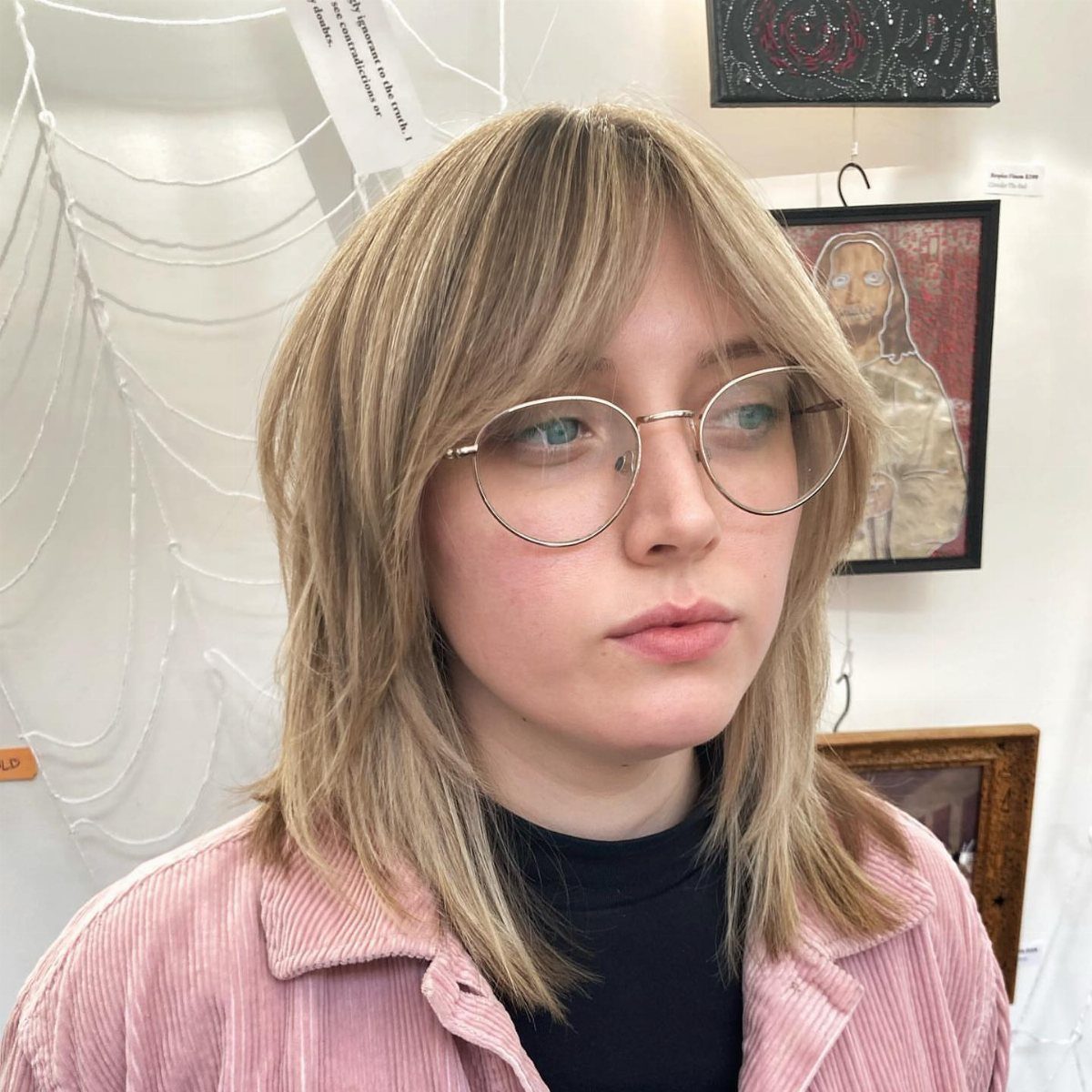 Shoulder-length blonde shag with wispy bangs and airy face-framing layers