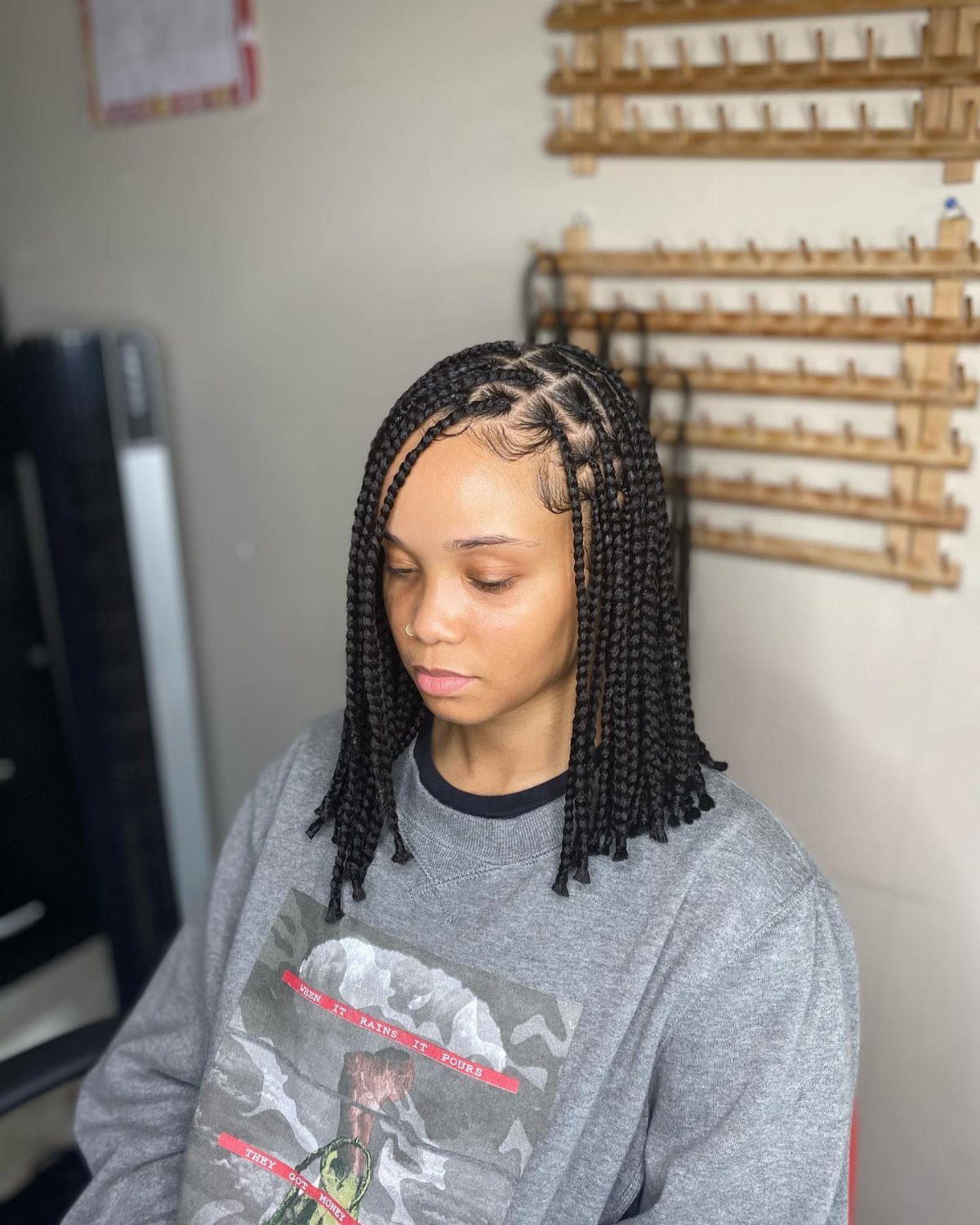 Person wearing shoulder-length box braids styled into a neat bob shape