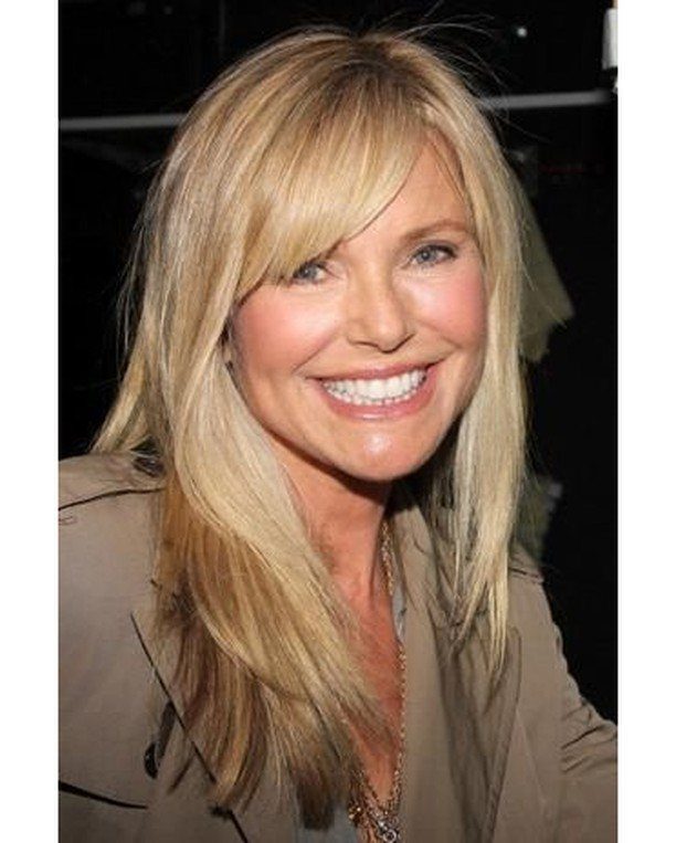Woman with fine blonde hair and long, tousled side-swept bangs