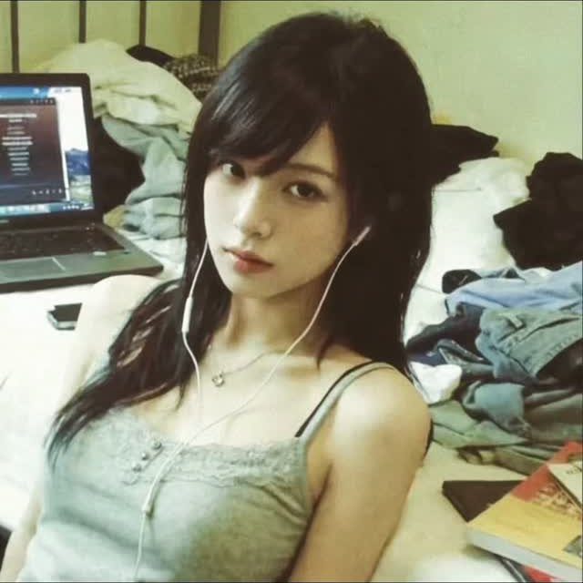 Woman with long dark hair and a full, side-swept bang