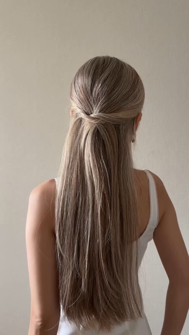 Long straight hair gathered into a half-up twist, with the rest hanging loose