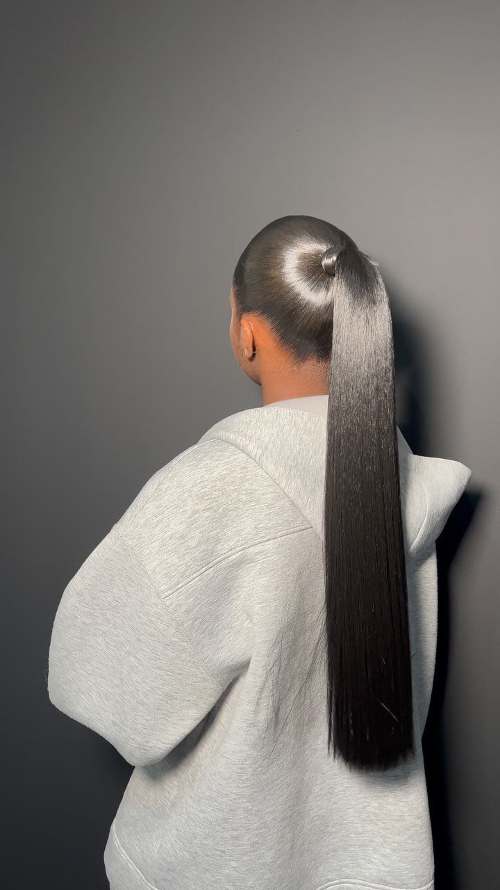 Long straight dark hair styled in a sleek high ponytail