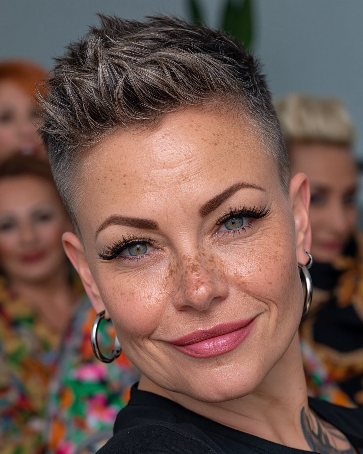 Woman with a tousled, forward-swept textured crop and closely cut sides