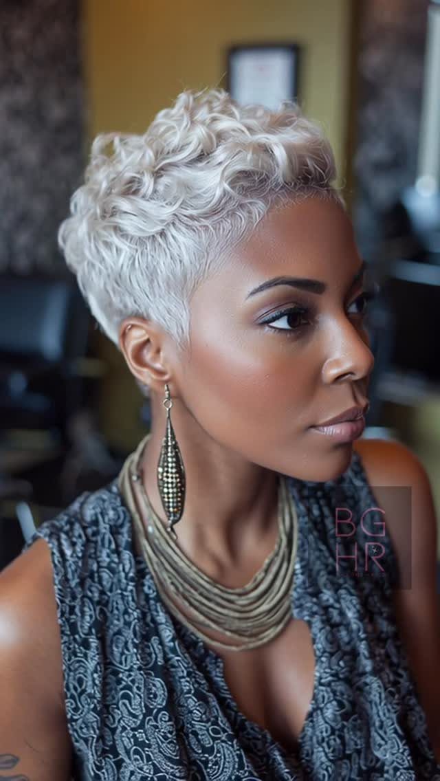 Woman showing a short platinum pixie with textured curls and closely trimmed sides