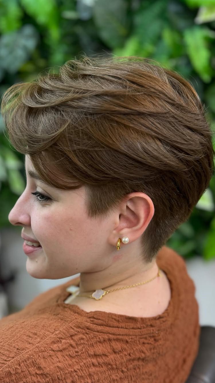 Short brown layered pixie with a long side-swept fringe