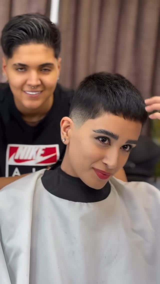Short dark textured crop with fringe and tapered faded sides in a salon