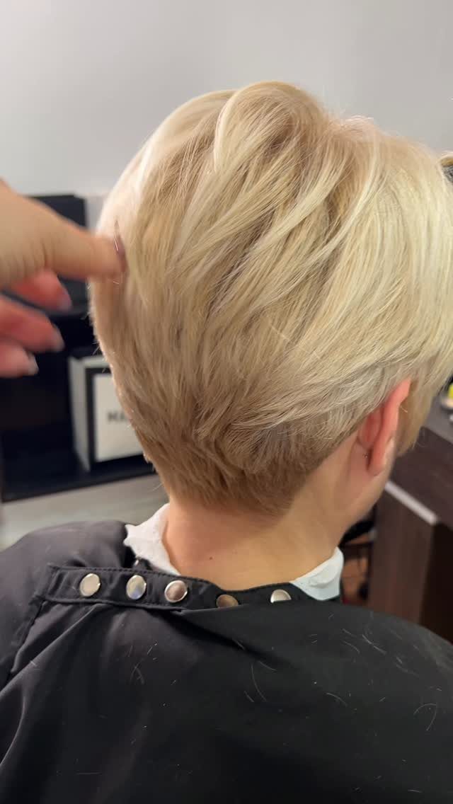 Blonde short crop haircut with layered volume and tapered nape
