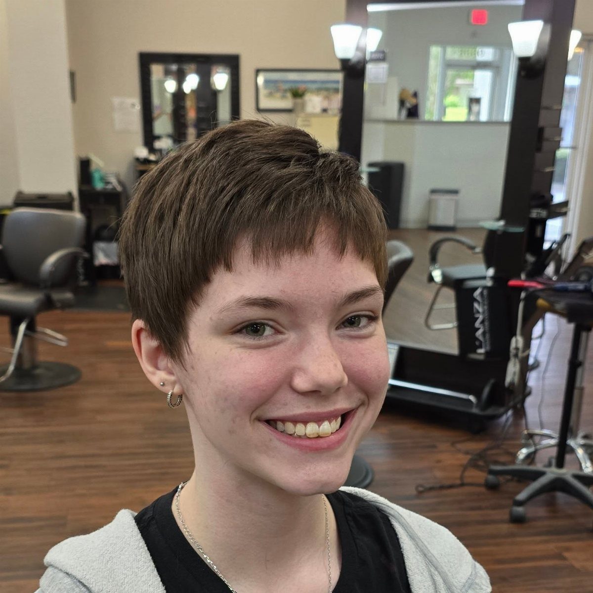 Short brown textured crop with a soft fringe in a hair salon