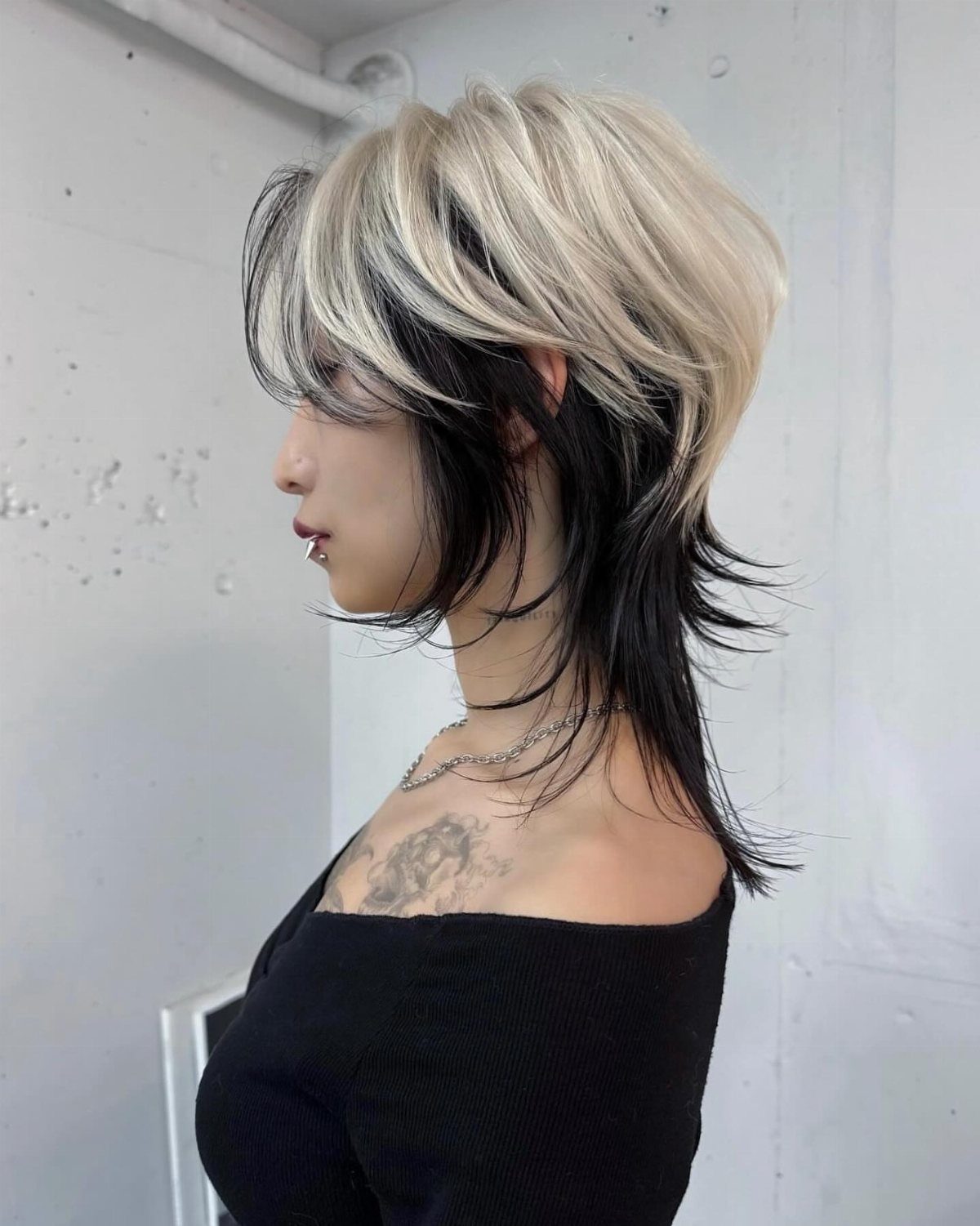 Side-profile person showing a choppy layered two-tone two block haircut