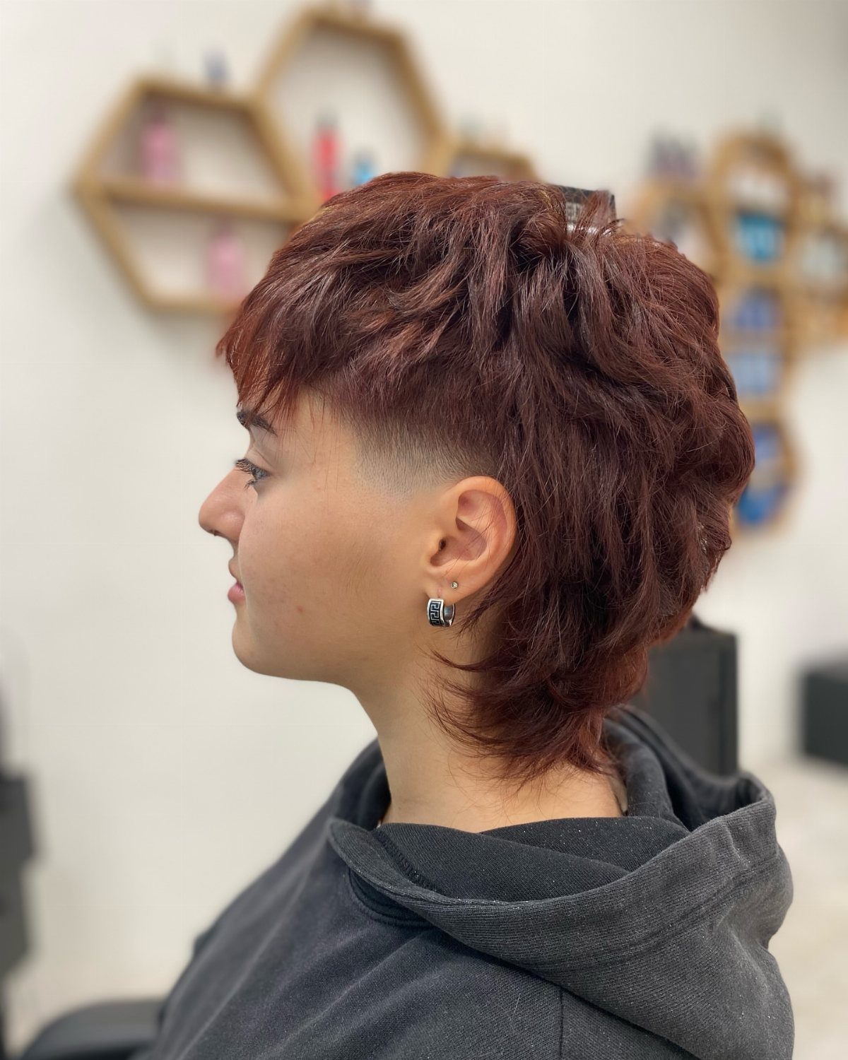 Person displaying a reddish-brown two block mullet with short sides and a longer back
